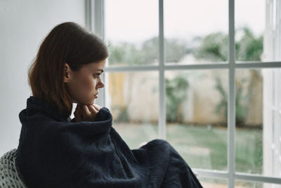 Woman looking through window