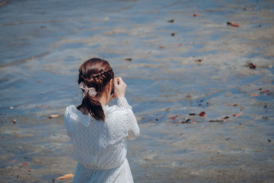 Rear view of woman standing on beach