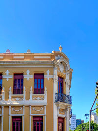 Low angle view of building against clear blue sky