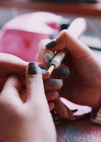 Cropped hand of woman doing a manicure