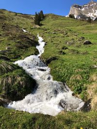 Scenic view of waterfall against sky