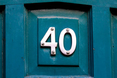 Close-up of text on blue door