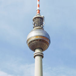 Low angle view of communications tower against sky in city