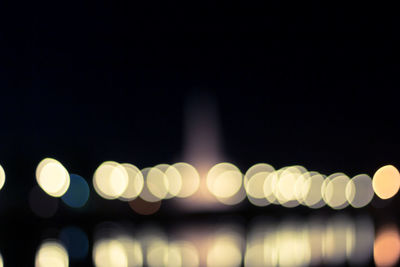 Defocused image of illuminated city at night