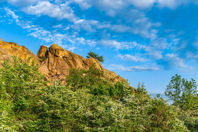 Low angle view of rock formation against sky