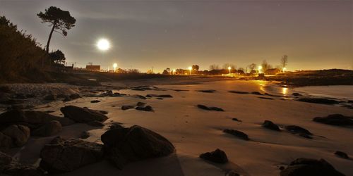 Scenic view of beach against sky during sunset