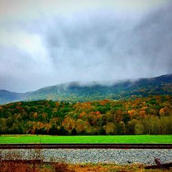 Scenic view of mountains against cloudy sky