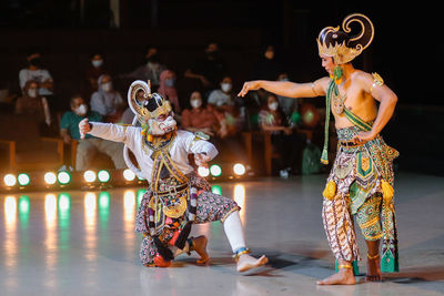 Portrait of young woman standing on stage