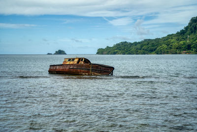 Boat in sea against sky