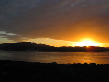 Scenic view of lake against sky during sunset