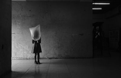 Rear view of man walking in tunnel