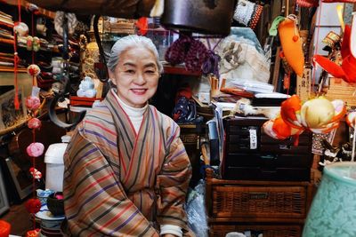 Portrait of smiling young man standing in market