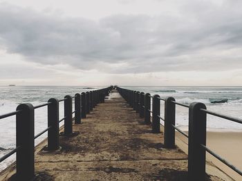 Pier over sea against sky