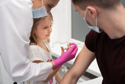 Midsection of doctor examining patient at clinic