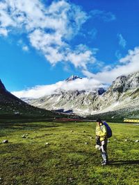 Full length of man on snowcapped mountain against sky