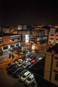 High angle view of illuminated buildings in city at night