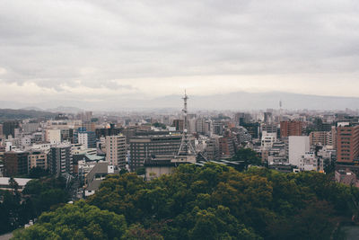 High angle view of cityscape against cloudy sky