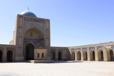 Low angle view of historic building against clear blue sky