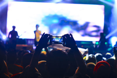 People enjoying music concert at night