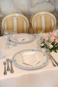 Table set for the wedding reception. plate cutlery and napkins, with flowers in the centerpiece
