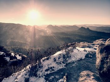Scenic view of snowcapped mountains against sky during sunset