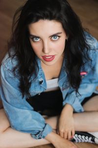 Portrait of young woman sitting at home converse