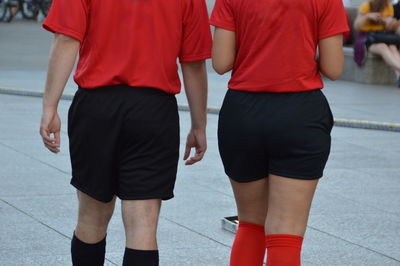 Midsection of female soccer players wearing red jersey