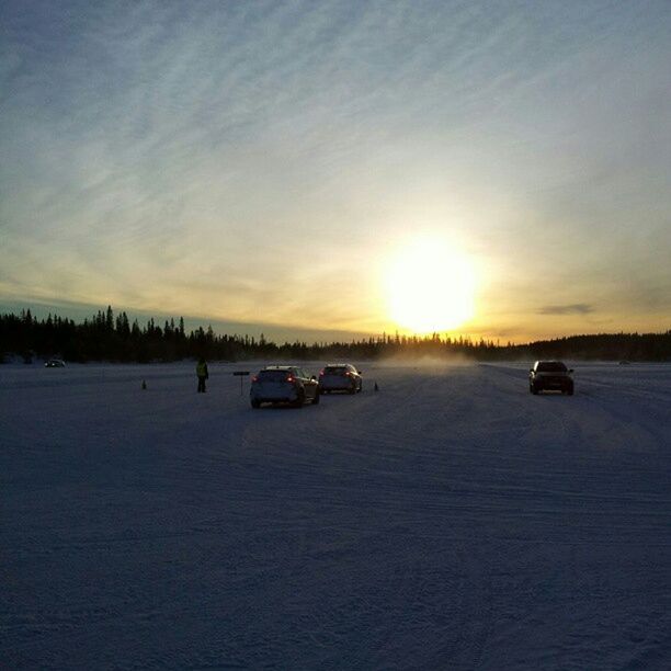 transportation, mode of transport, land vehicle, sunset, car, sun, sky, stationary, snow, winter, cloud - sky, cold temperature, parking, weather, travel, road, sunlight, nature, orange color, sunbeam