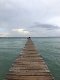 Pier over sea against sky