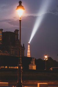 Illuminated buildings against sky at night