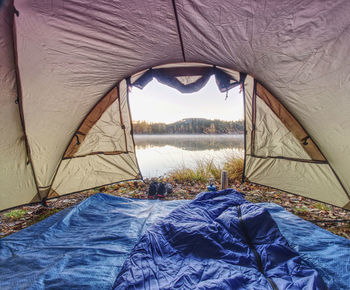 Scenic view of tent on shore against sky