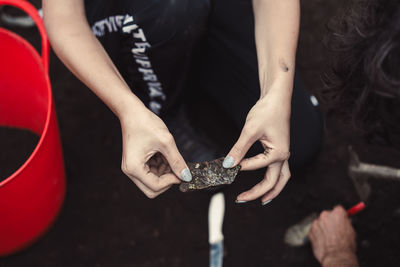 Close-up of hand and an artifact at an archeological site