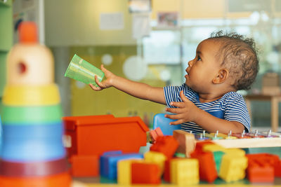 Cute boy holding toy toys