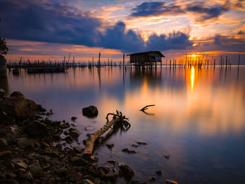 Scenic view of lake against sky during sunset