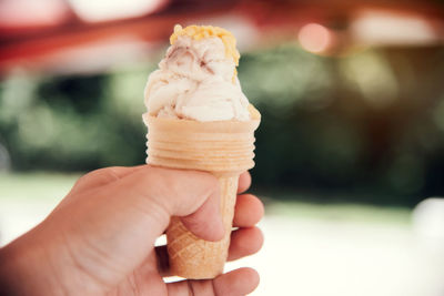 Close-up of hand holding ice cream cone