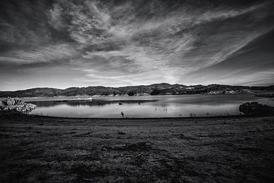 Scenic view of lake against sky during winter