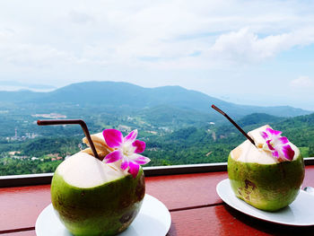 Close-up of coconut drink served on table