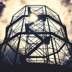 Low angle view of silhouette built structure against sky
