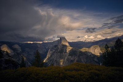 Scenic view of mountains against cloudy sky