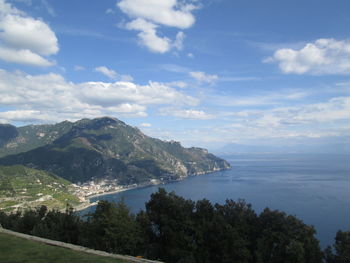 Scenic view of sea and mountains against sky