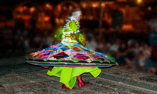 Person holding multi colored umbrella