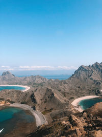 Scenic view of mountain range against blue sky