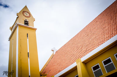 Low angle view of clock tower against sky