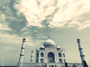 Low angle view of historical building against cloudy sky