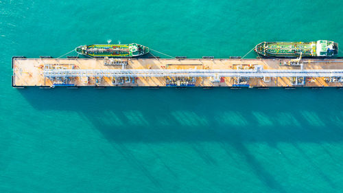 Aerial view of ship by pier over sea