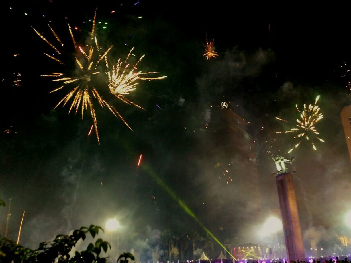 firework display, celebration, event, firework - man made object, night, arts culture and entertainment, exploding, sparks, long exposure, illuminated, low angle view, firework, smoke - physical structure, motion, excitement, blurred motion, outdoors, multi colored, celebration event, sparkler, sky, enjoyment, performance, large group of people, crowd