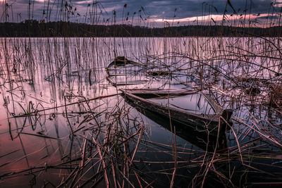 Sailboats moored in lake against sky