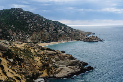 Rock formations by sea against sky