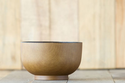 Close-up of drink on table against wall