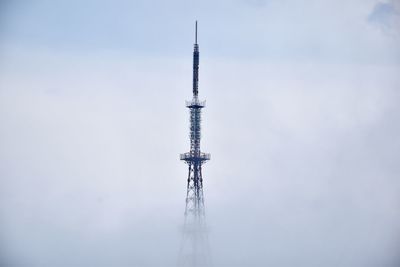 Low angle view of crane against sky